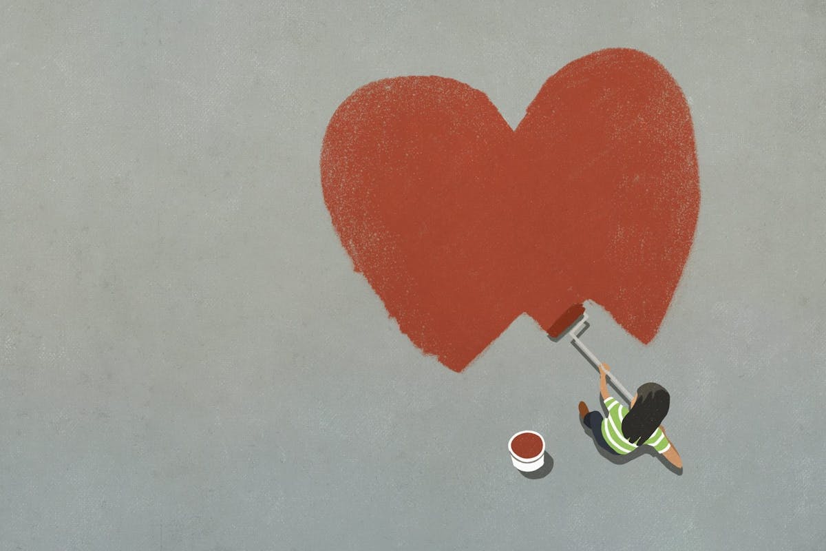 Woman painting a red heart